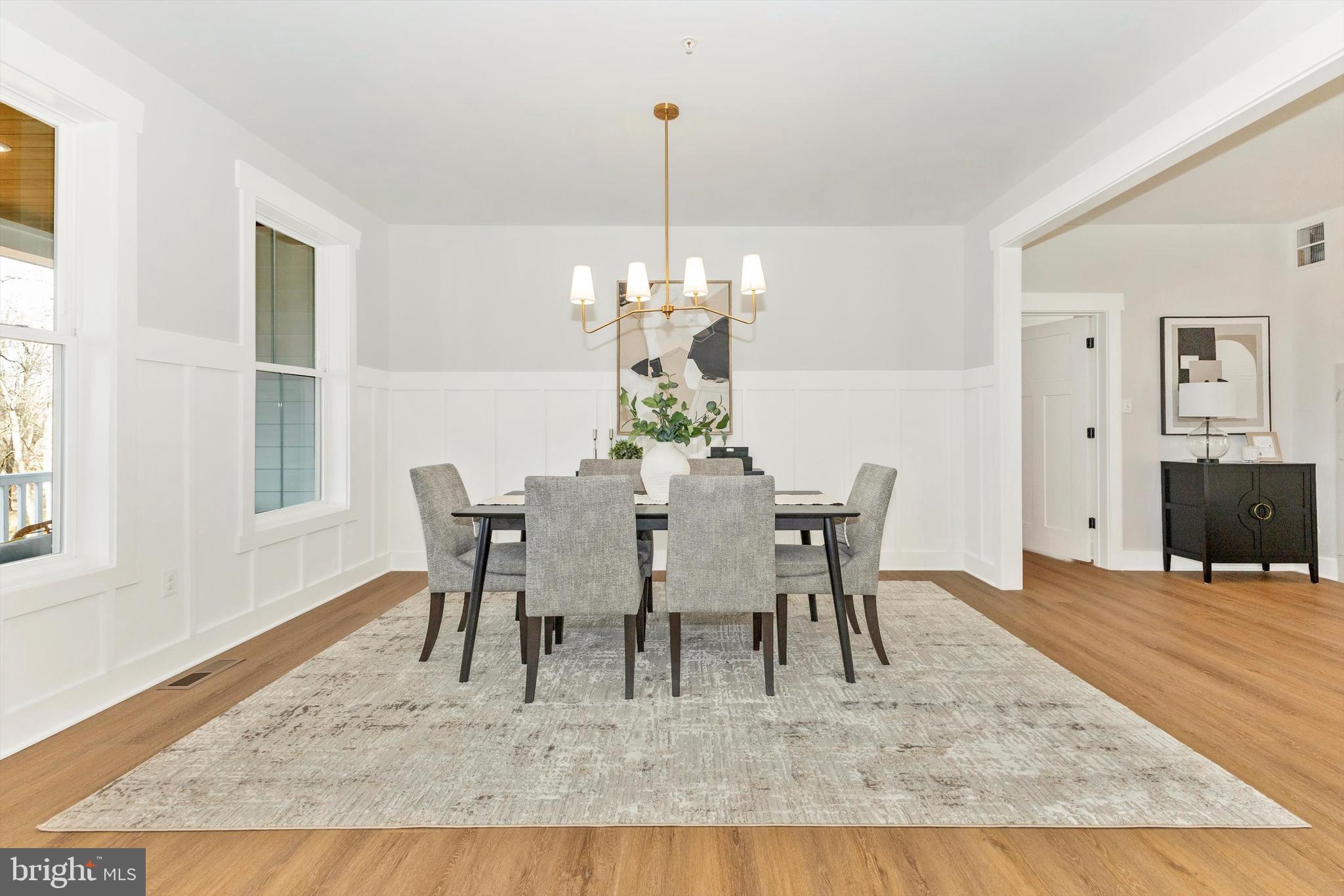 1199 Hoods Mill Road Cooksville, MD 21723 - Photo 13 of 86 a dining room with wooden floor a chandelier a wooden table and chairs
