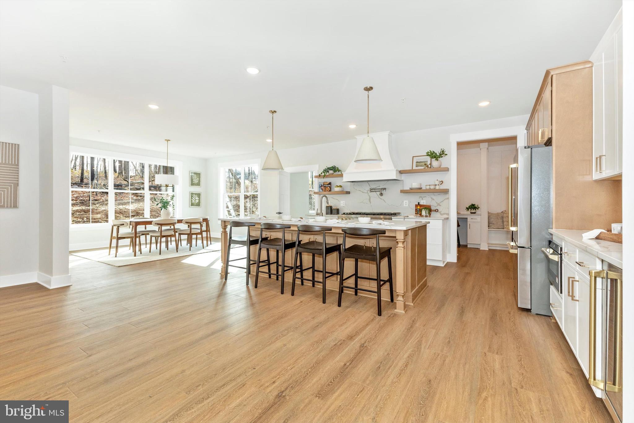 1199 Hoods Mill Road Cooksville, MD 21723 - Photo 14 of 86 a open kitchen with stainless steel appliances granite countertop a stove top oven a dining table and chairs with wooden floor