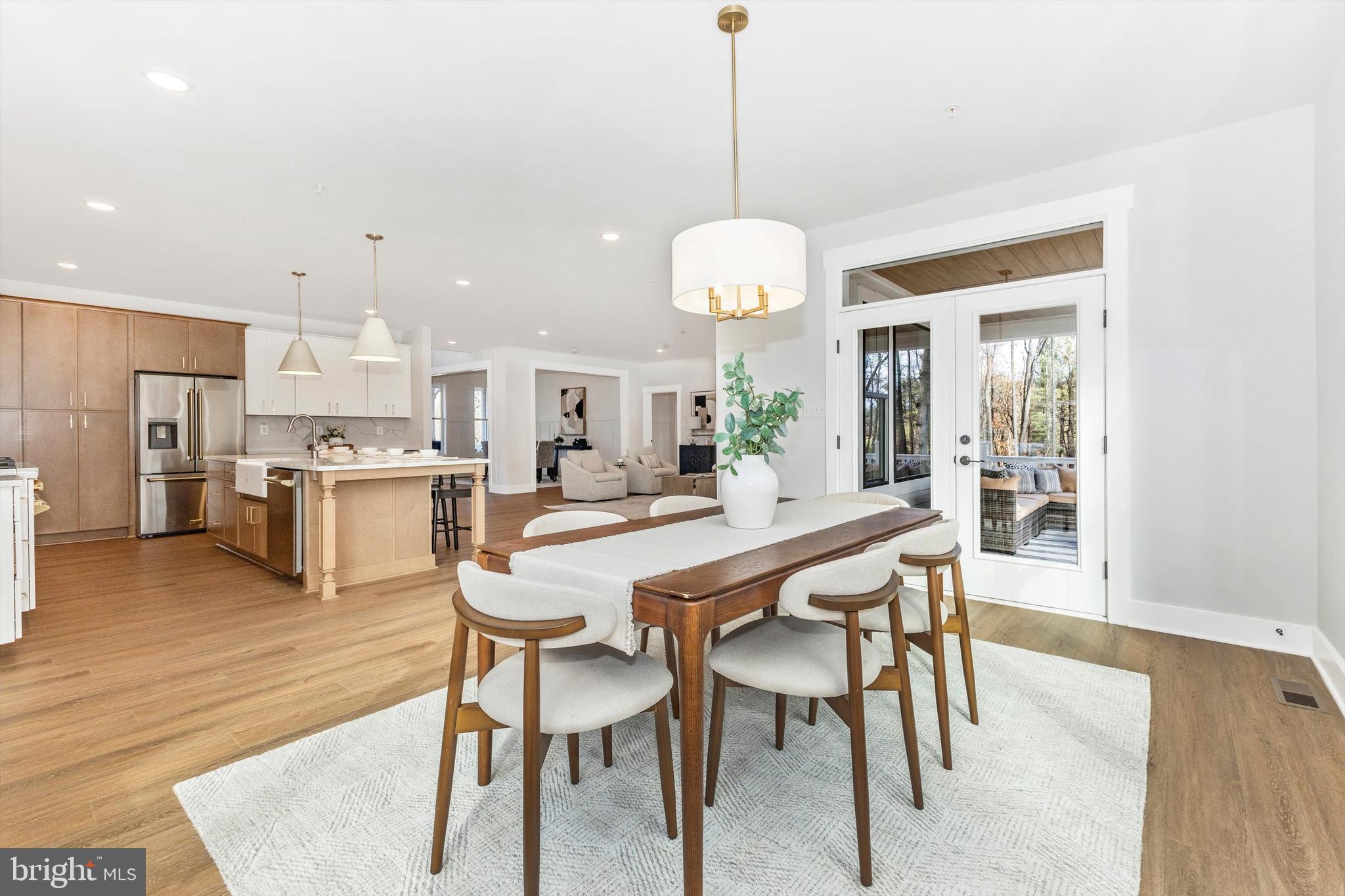 1199 Hoods Mill Road Cooksville, MD 21723 - Photo 17 of 86 a dining room with stainless steel appliances kitchen island a table and chairs