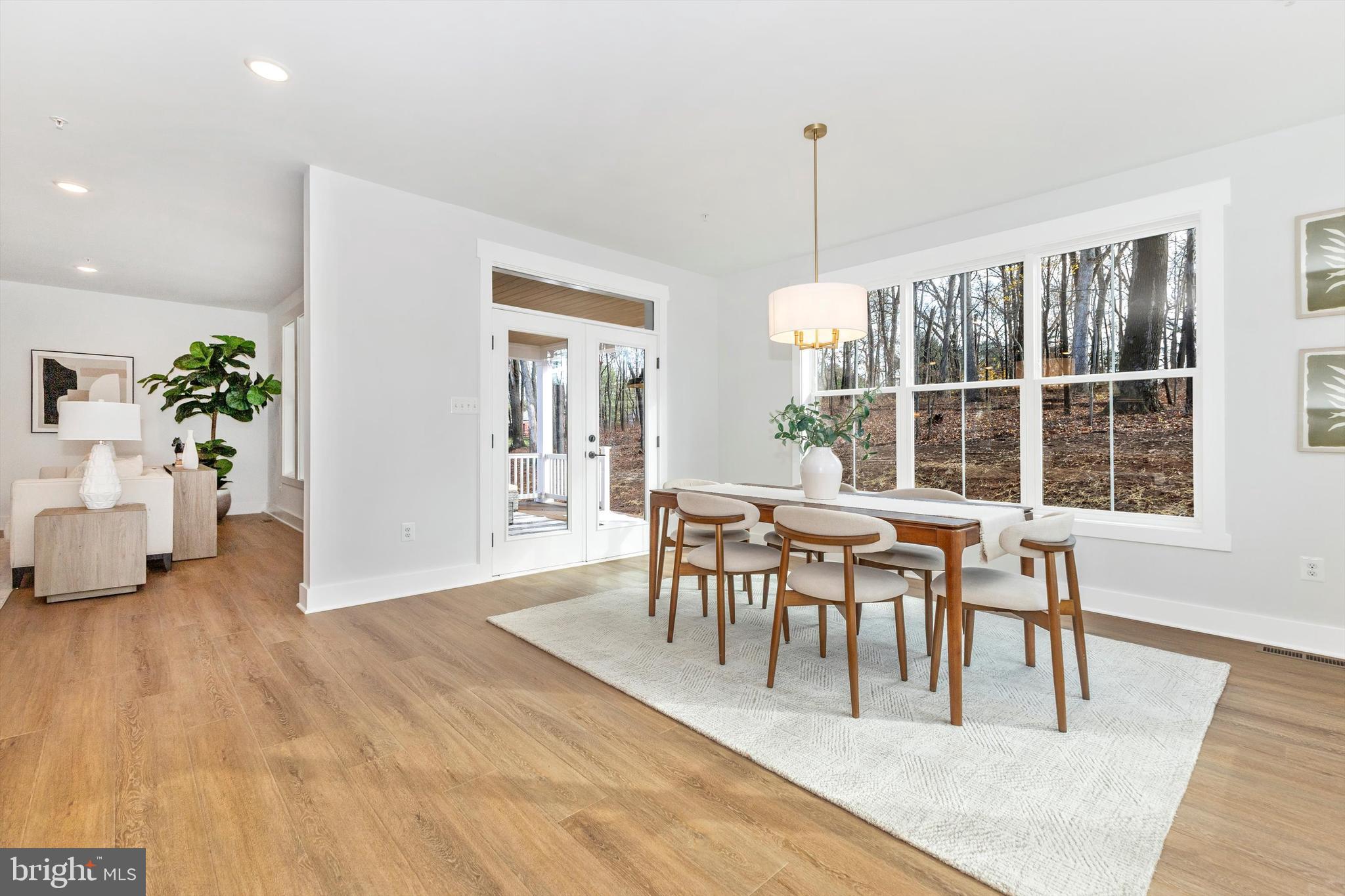 1199 Hoods Mill Road Cooksville, MD 21723 - Photo 18 of 86 a dining room with furniture potted plants and wooden floor