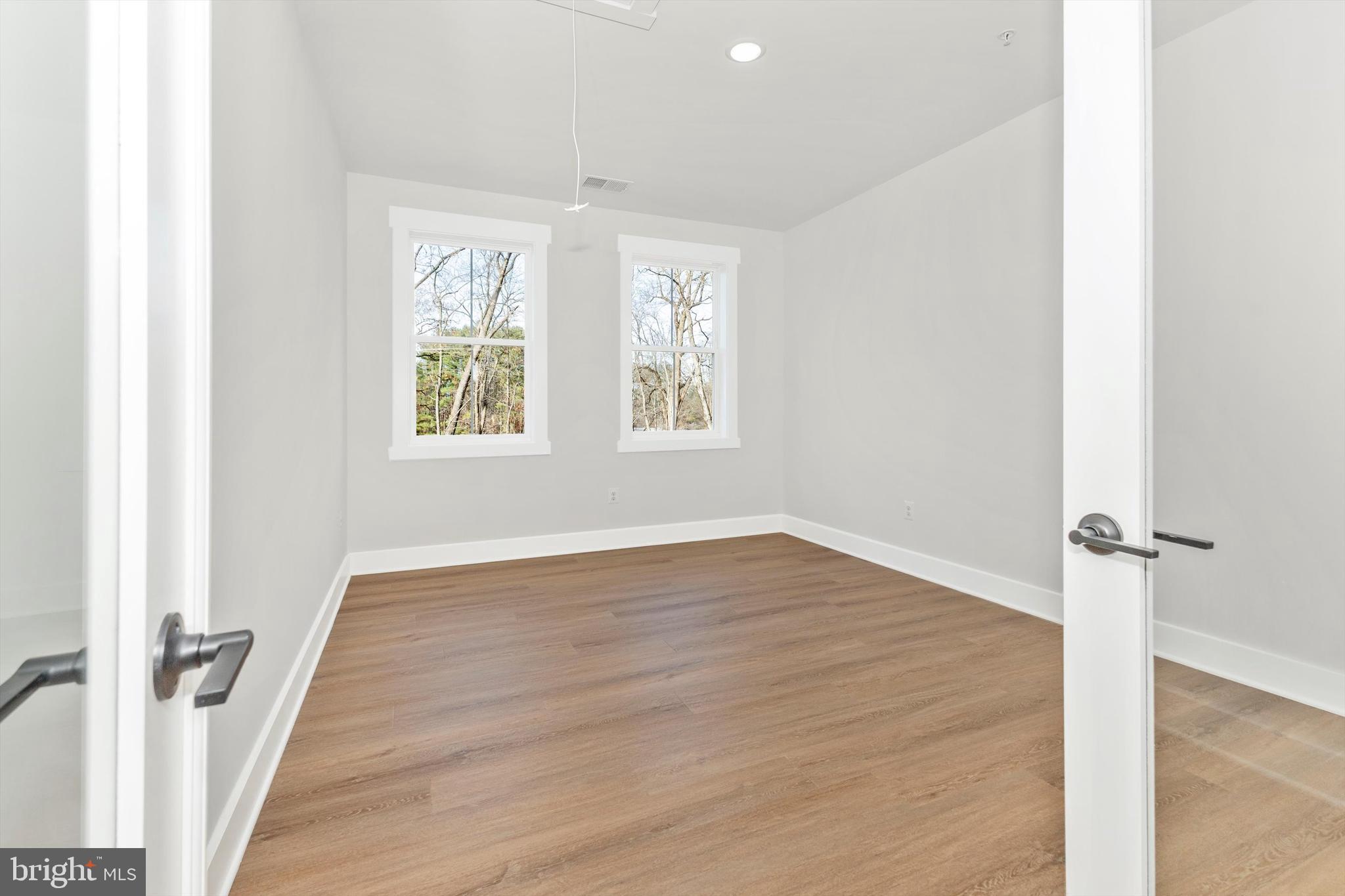 1199 Hoods Mill Road Cooksville, MD 21723 - Photo 38 of 86 an empty room with wooden floor and windows