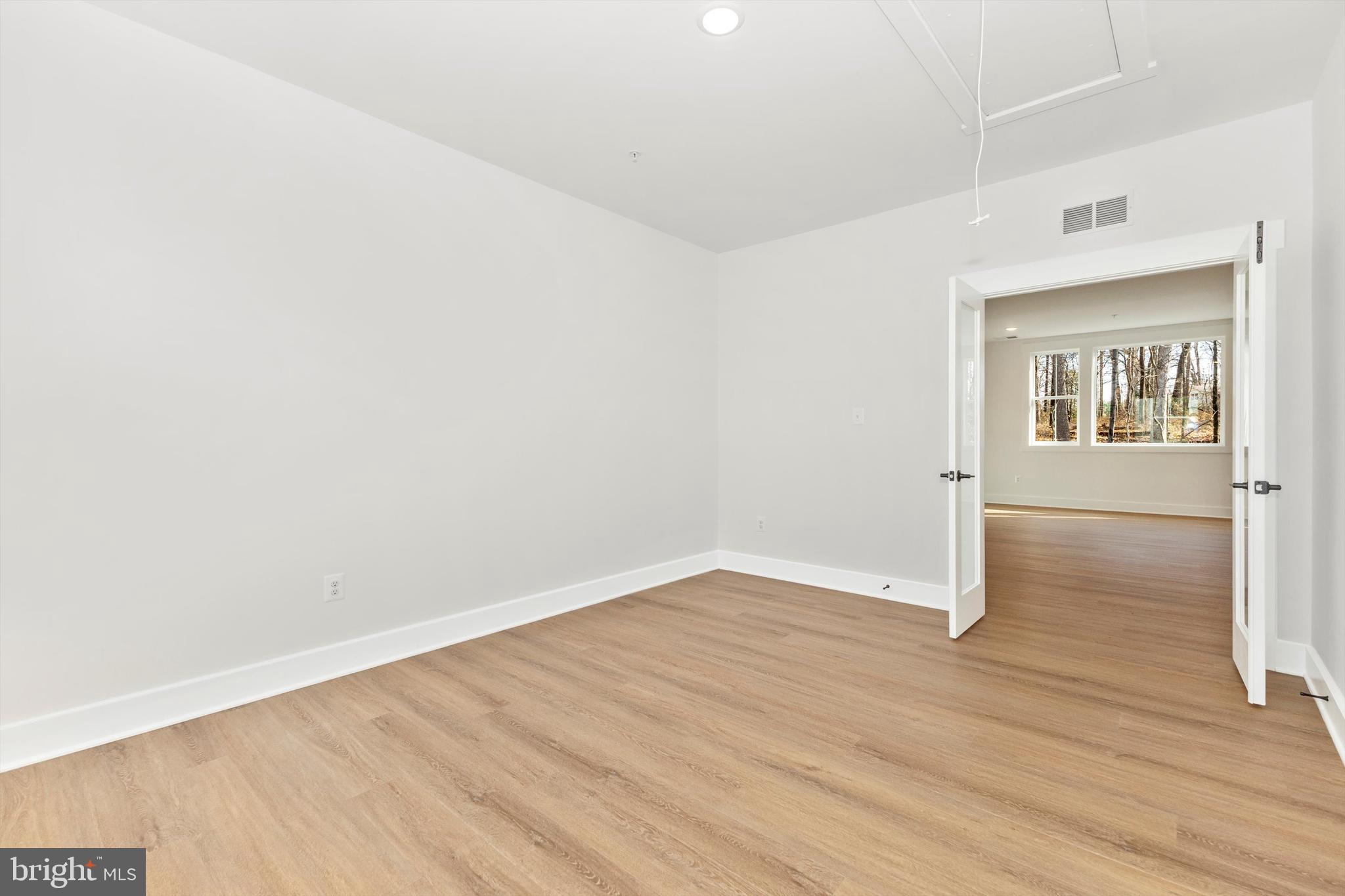 1199 Hoods Mill Road Cooksville, MD 21723 - Photo 39 of 86 an empty room with wooden floor and windows