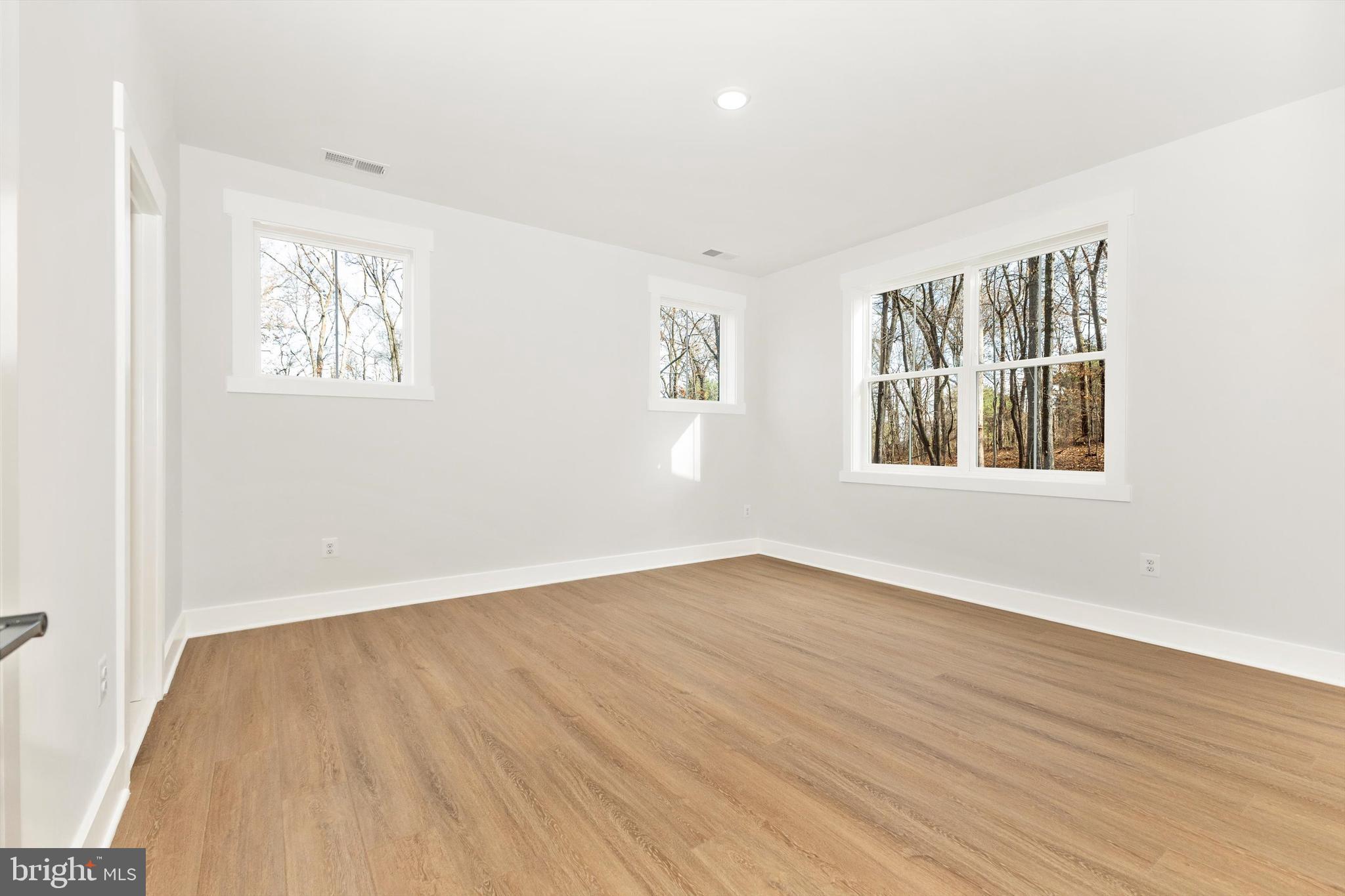 1199 Hoods Mill Road Cooksville, MD 21723 - Photo 40 of 86 an empty room with wooden floor and windows
