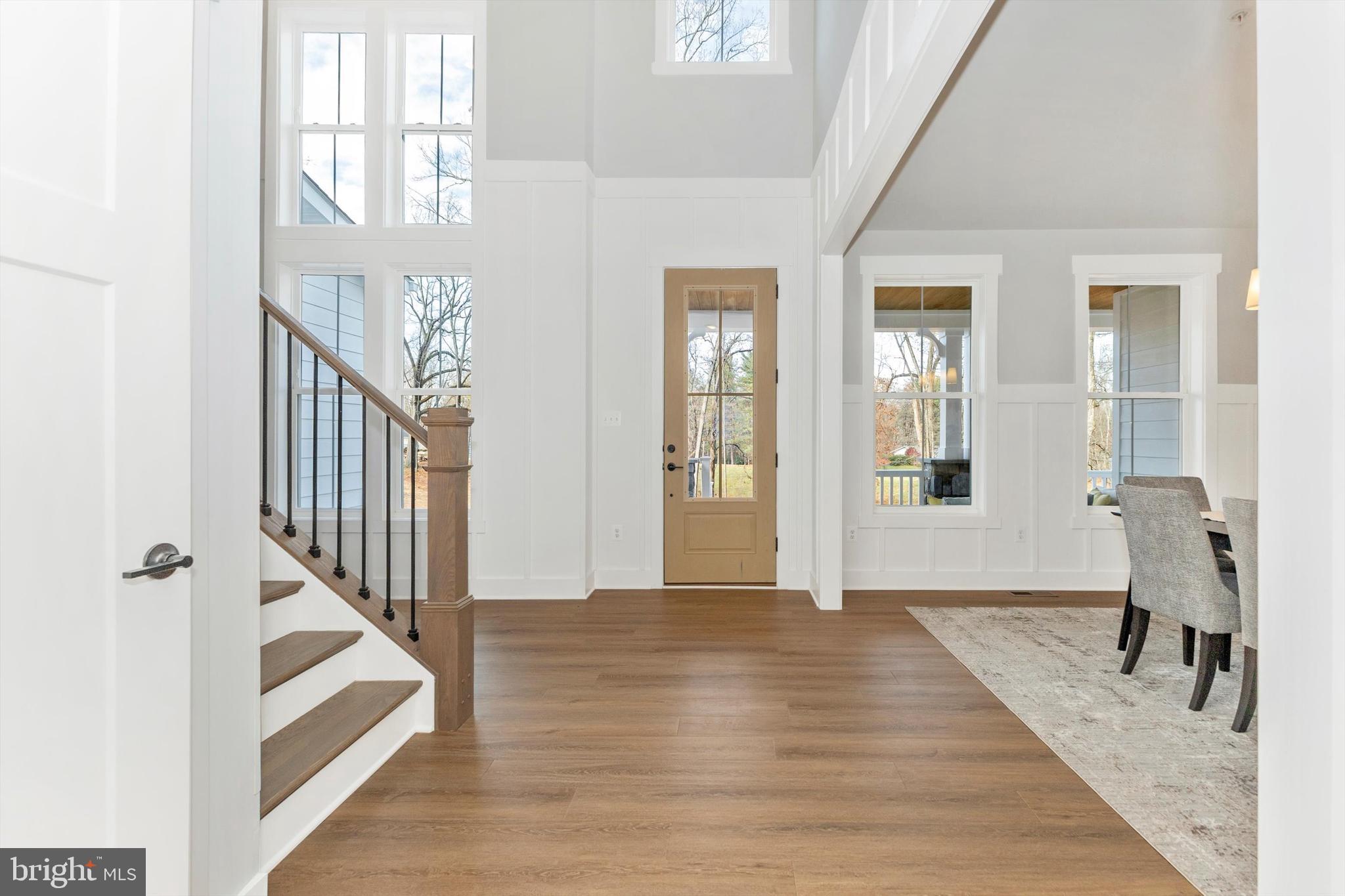 1199 Hoods Mill Road Cooksville, MD 21723 - Photo 4 of 86 a view of an entryway with wooden floor leading to a furnished livingroom and windows