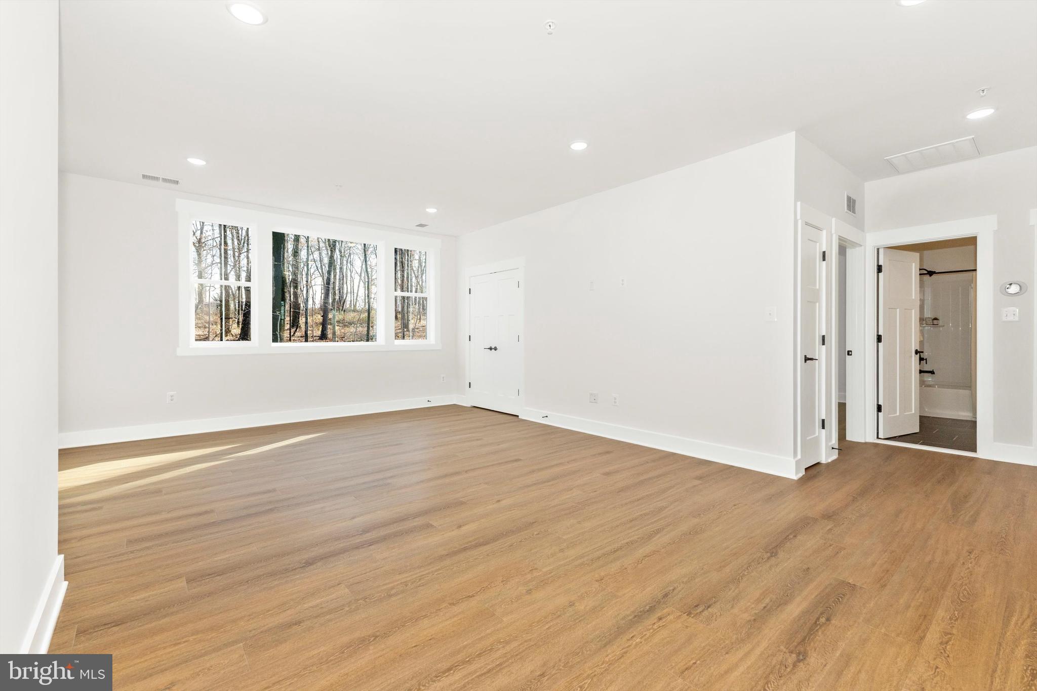 1199 Hoods Mill Road Cooksville, MD 21723 - Photo 43 of 86 an empty room with wooden floor and windows