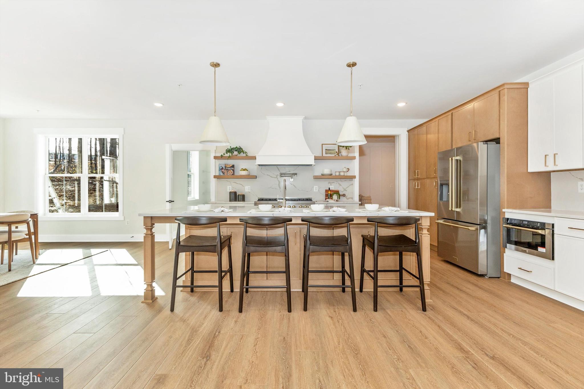 1199 Hoods Mill Road Cooksville, MD 21723 - Photo 6 of 86 a kitchen with stainless steel appliances a dining table chairs stove and refrigerator
