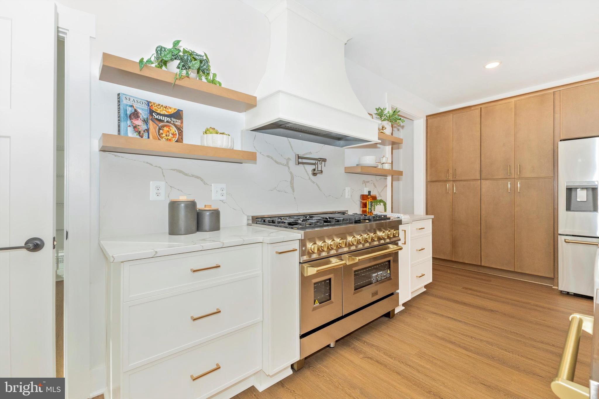 1199 Hoods Mill Road Cooksville, MD 21723 - Photo 7 of 86 a kitchen with stainless steel appliances a stove a chimney and wooden floor