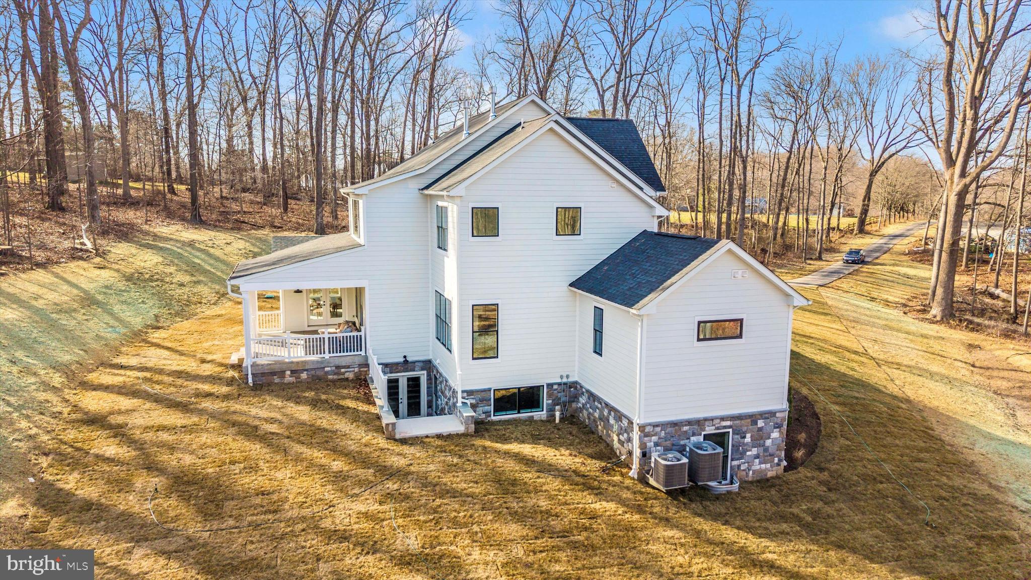 1199 Hoods Mill Road Cooksville, MD 21723 - Photo 73 of 86 a view of a white house with a yard and lawn chairs