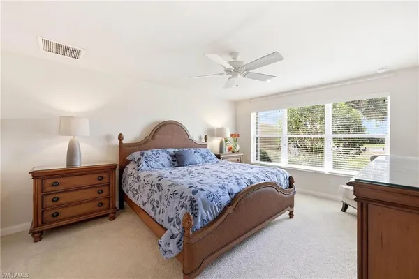 a bedroom with a bed dresser and a window