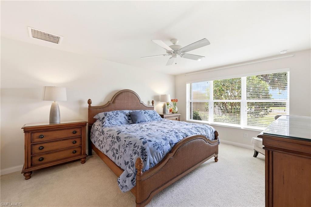 8664 Genova Court Naples, FL 34114 - Photo 11 of 46 a bedroom with a bed dresser and a window