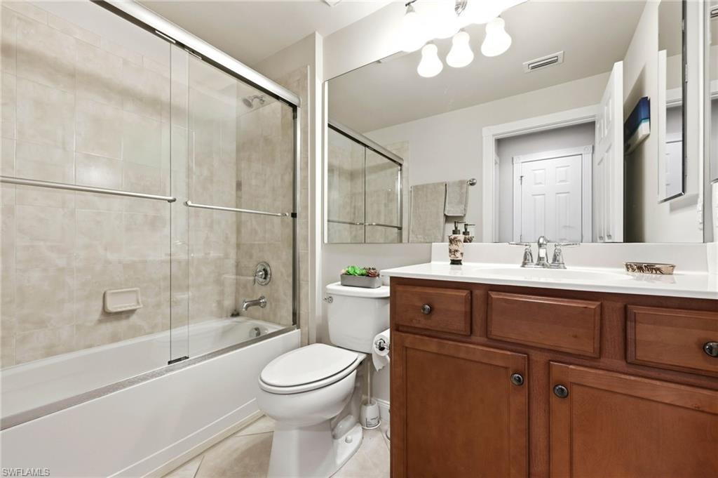 8664 Genova Court Naples, FL 34114 - Photo 19 of 46 a bathroom with a sink a toilet and shower