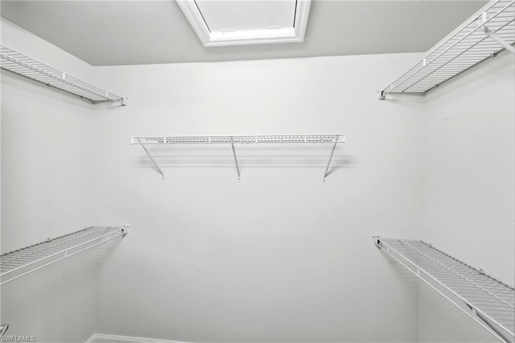 8664 Genova Court Naples, FL 34114 - Photo 20 of 46 a view of a room with racks on the wall