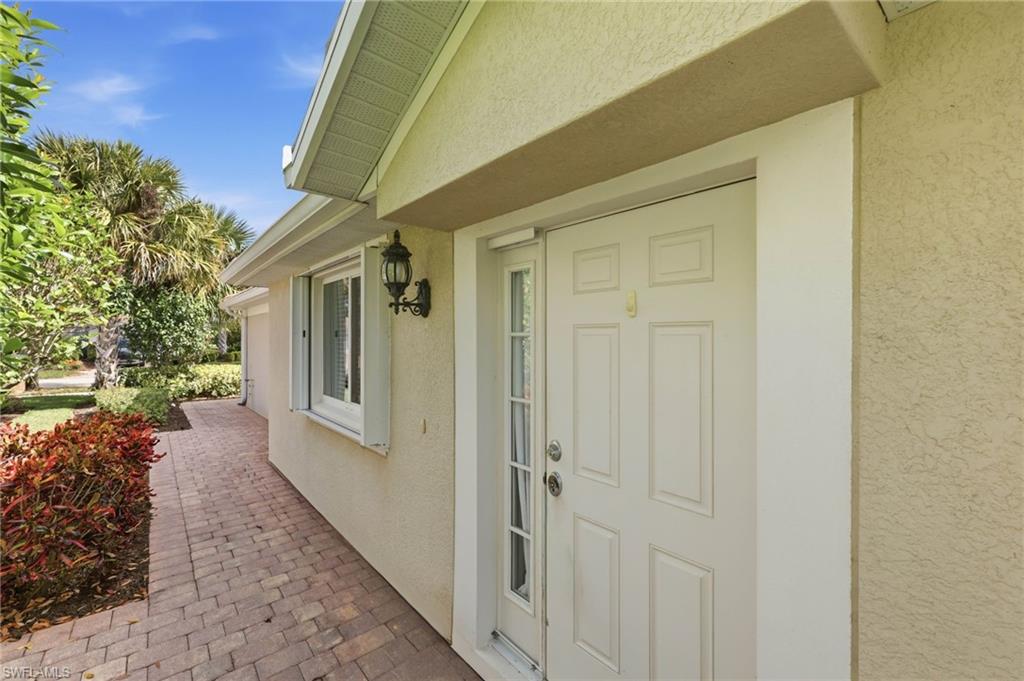 8664 Genova Court Naples, FL 34114 - Photo 2 of 46 a view of a house with a small backyard