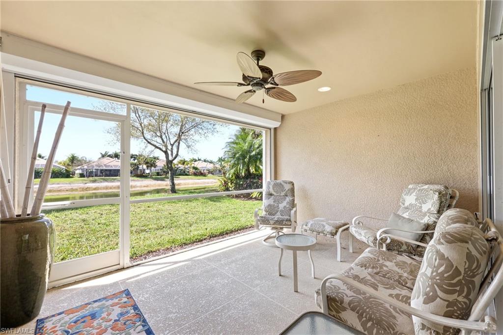8664 Genova Court Naples, FL 34114 - Photo 21 of 46 a living room with furniture and a large window