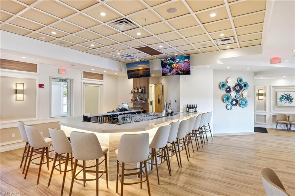 8664 Genova Court Naples, FL 34114 - Photo 23 of 46 a view of a dining room with furniture and wooden floor