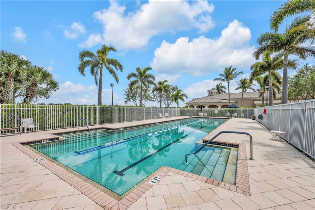 8664 Genova Court Naples, FL 34114 - Photo 32 of 46 a view of a swimming pool with a lounge chairs