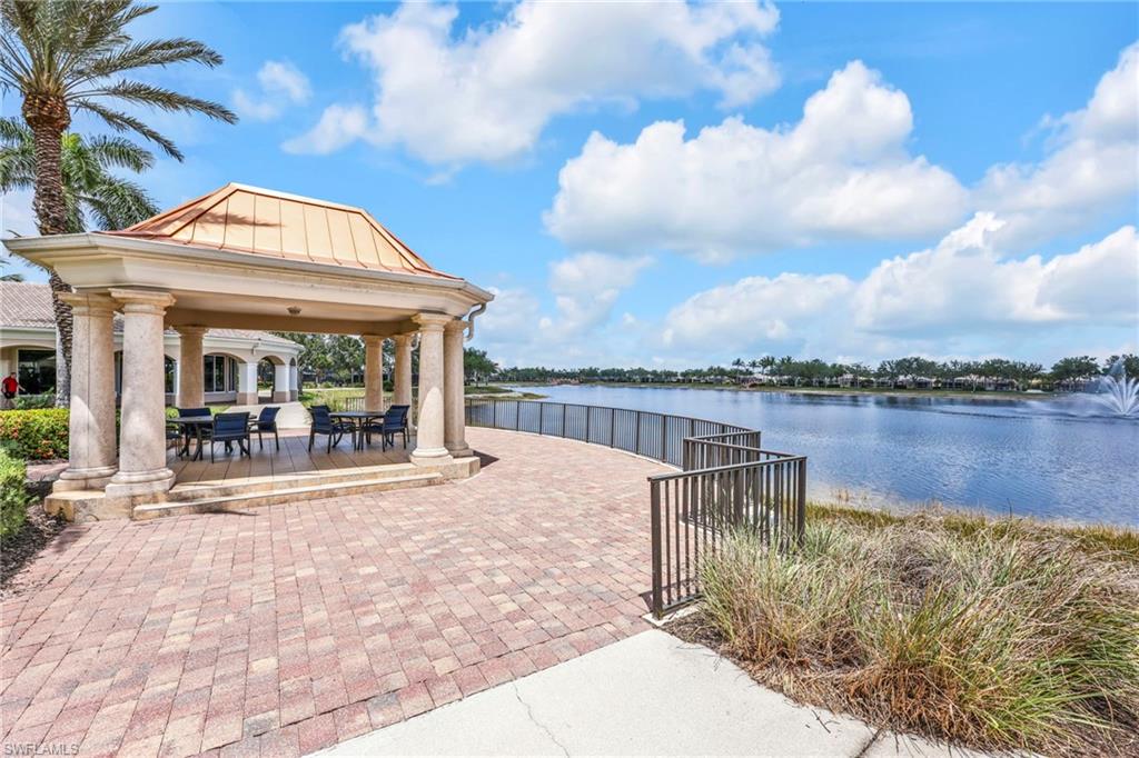 8664 Genova Court Naples, FL 34114 - Photo 34 of 46 a view of a house with lake view and boat