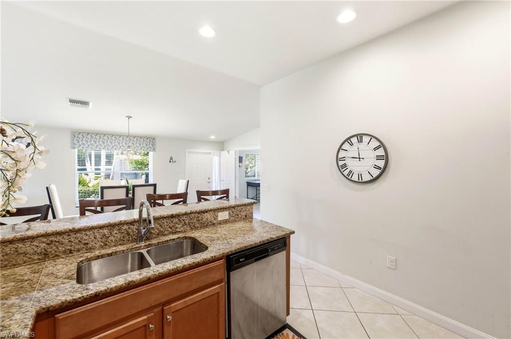 8664 Genova Court Naples, FL 34114 - Photo 5 of 46 a view of a kitchen with a sink and cabinets
