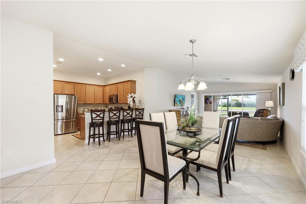 8664 Genova Court Naples, FL 34114 - Photo 6 of 46 a dining room with furniture and window