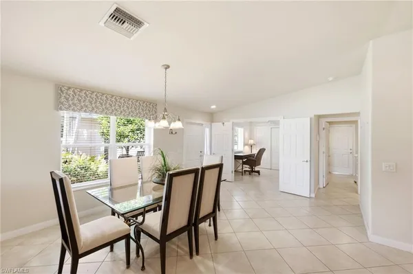 a dining room with furniture and window