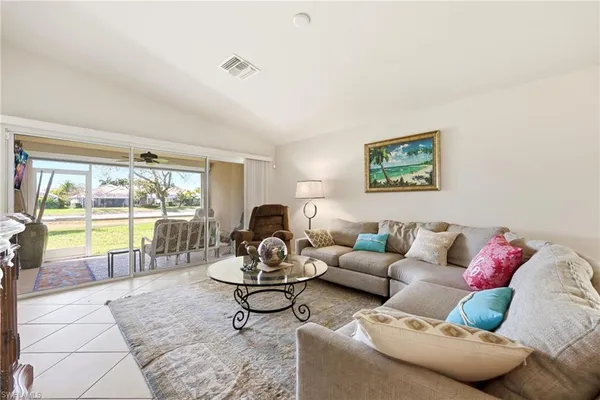 a living room with furniture and a large window with outer view