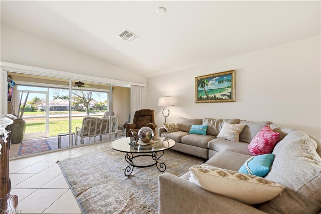 8664 Genova Court Naples, FL 34114 - Photo 8 of 46 a living room with furniture and a large window with outer view