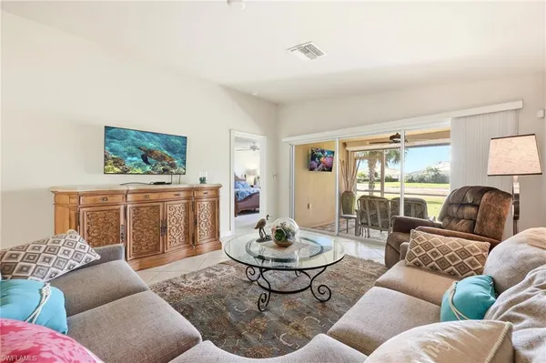 a living room with furniture a rug and a window