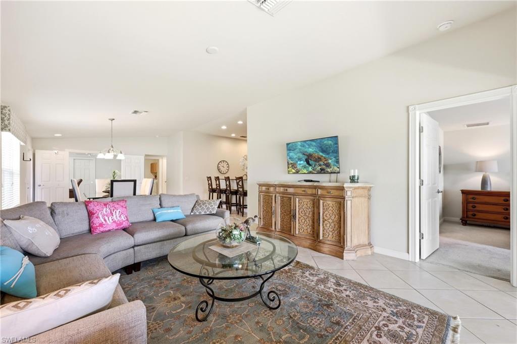 8664 Genova Court Naples, FL 34114 - Photo 10 of 46 a living room with furniture and a wooden floor
