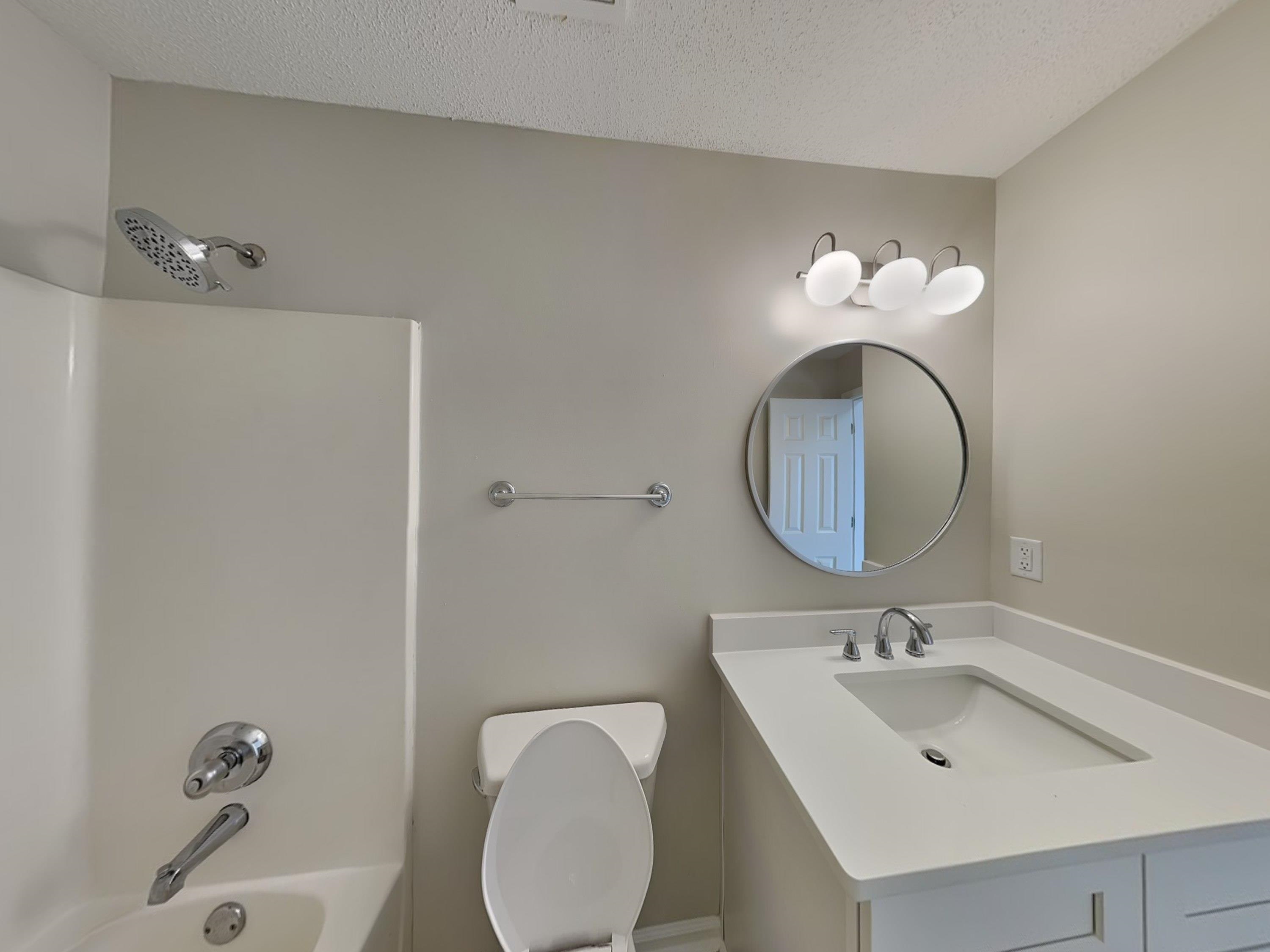 7902 Pinefrost Lane Memphis, TN 38125 - Photo 13 of 18 a bathroom with a toilet sink and mirror