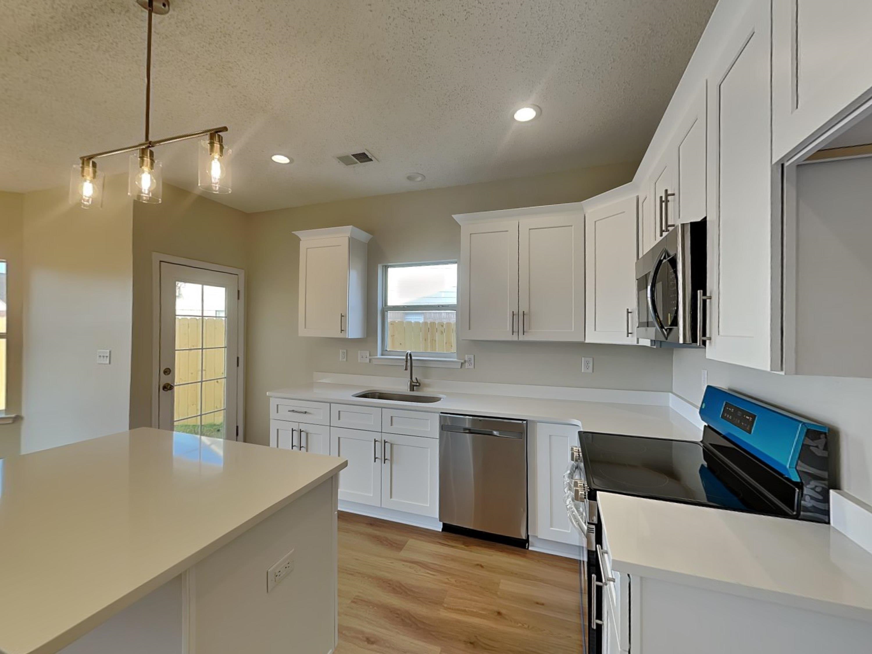 7902 Pinefrost Lane Memphis, TN 38125 - Photo 4 of 18 a kitchen with stainless steel appliances granite countertop a sink a stove and a refrigerator