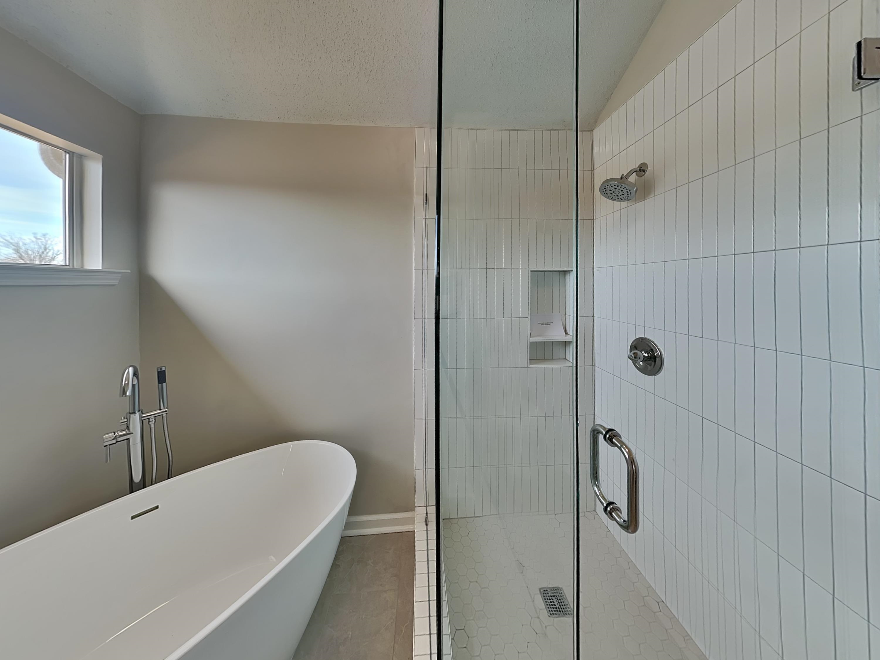 7902 Pinefrost Lane Memphis, TN 38125 - Photo 9 of 18 a bathroom with a tub and shower