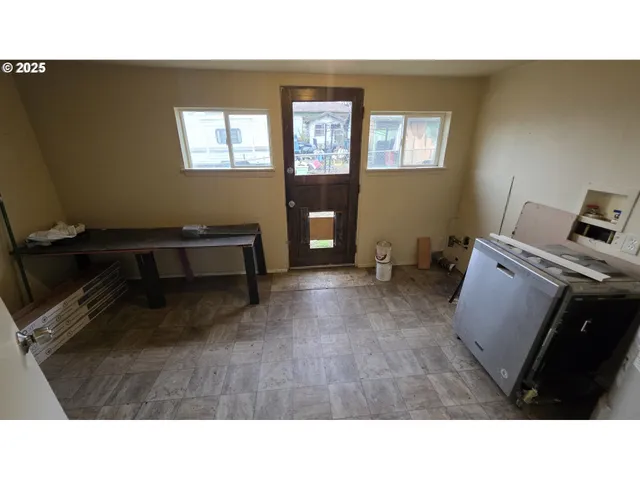 a kitchen with a refrigerator and microwave