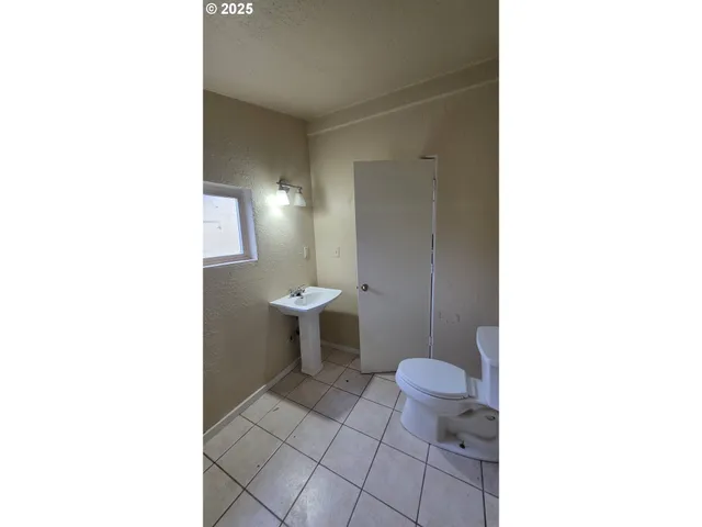 a open hall with a painting on the wall