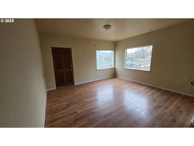 a house that has a lot of windows and plants