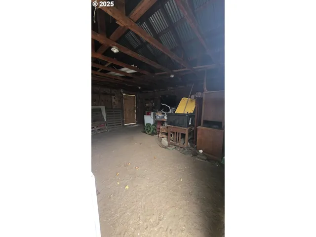 a view of a room with a table and chairs in a patio