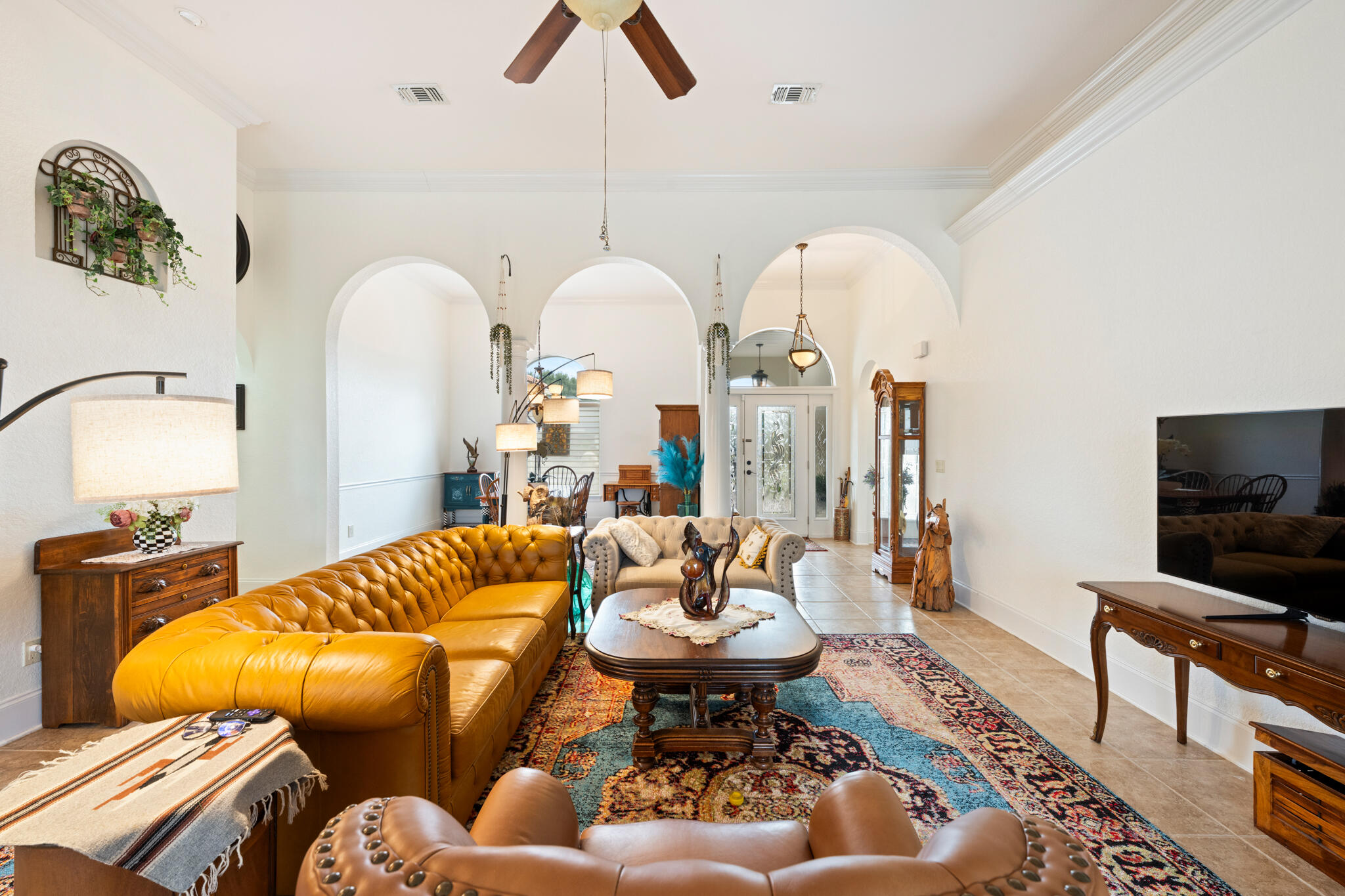 2615 Masters Boulevard Navarre, FL 32566 - Photo 25 of 51 a living room with furniture a rug and a chandelier