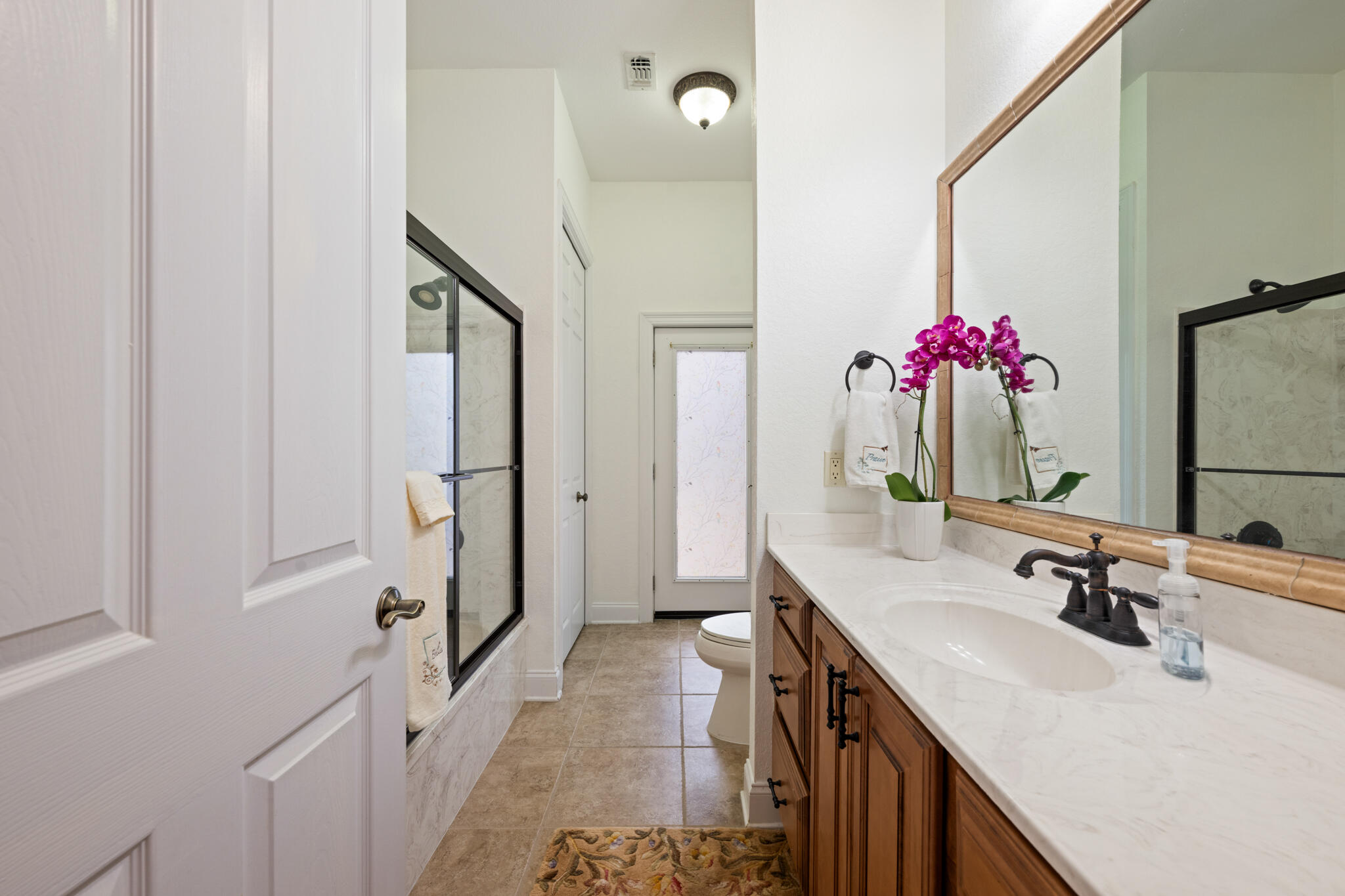 2615 Masters Boulevard Navarre, FL 32566 - Photo 30 of 51 a bathroom with a sink vanity and a mirror