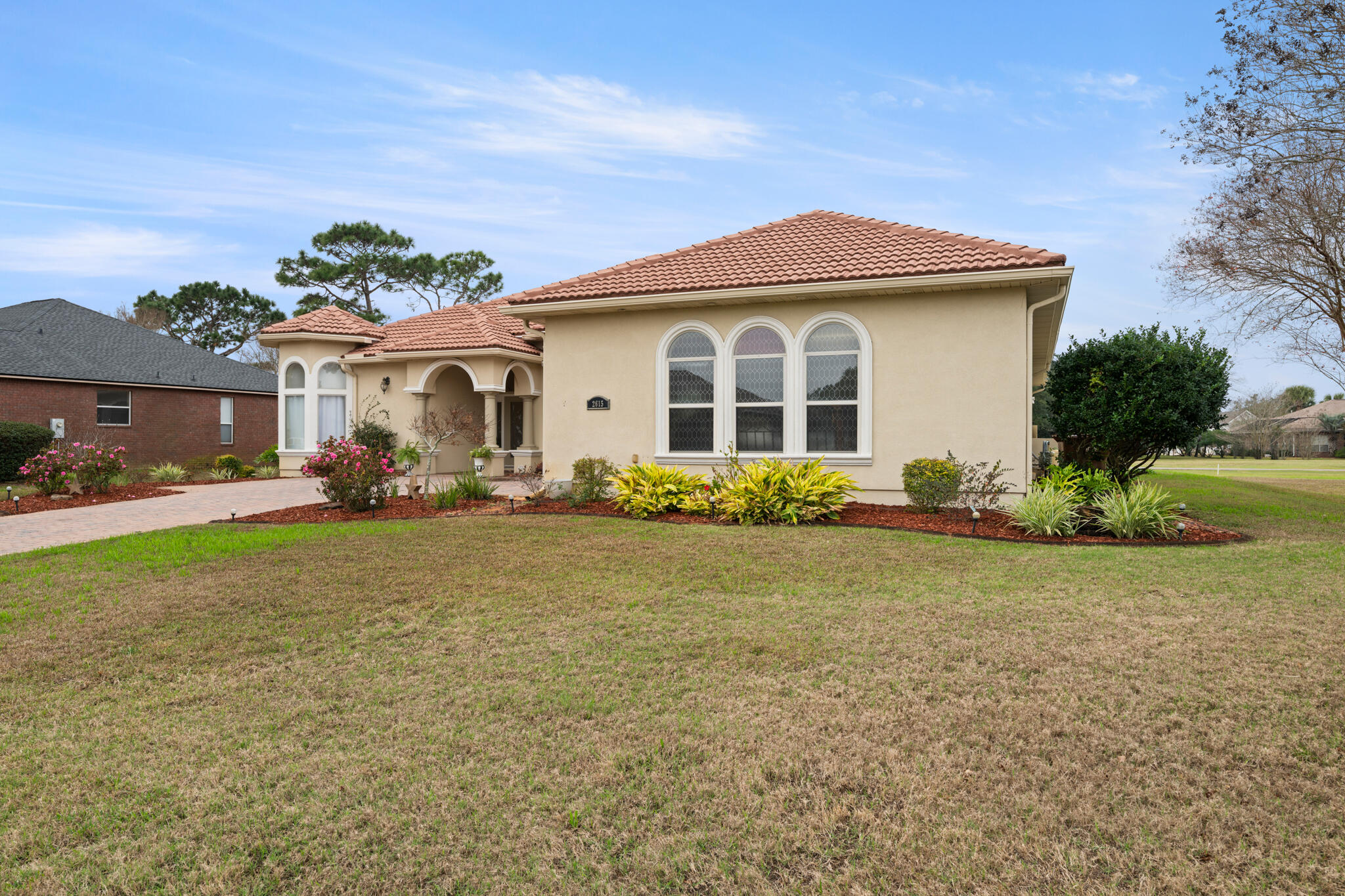 2615 Masters Boulevard Navarre, FL 32566 - Photo 50 of 51 a front view of a house with a yard