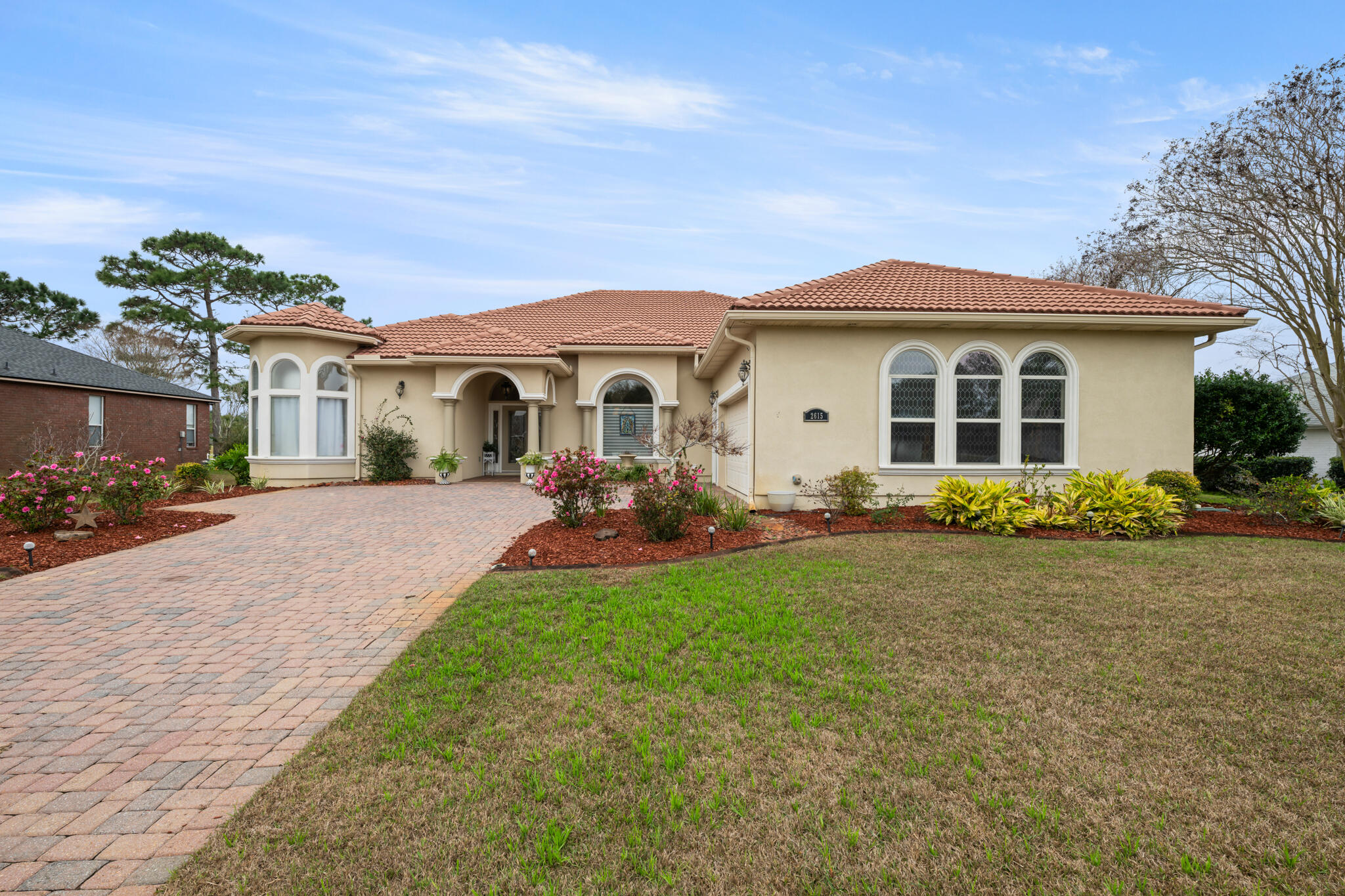 2615 Masters Boulevard Navarre, FL 32566 - Photo 51 of 51 a front view of a house with a yard