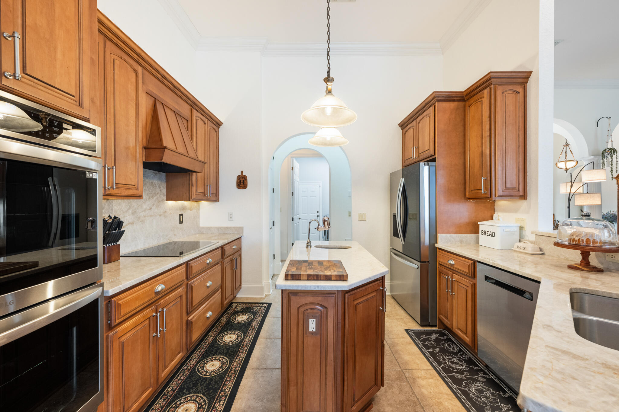 2615 Masters Boulevard Navarre, FL 32566 - Photo 8 of 51 a kitchen with stainless steel appliances a stove cabinets and a kitchen island