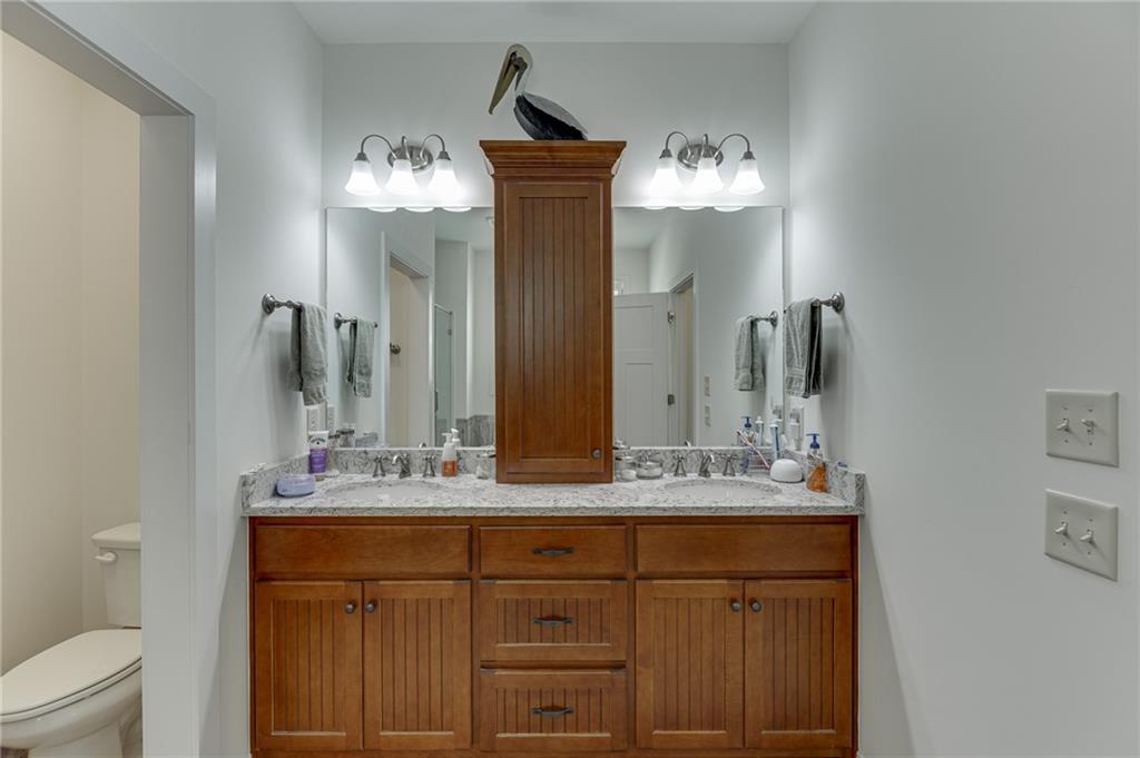 7660 Fern Lane Lula, GA 30554 - Photo 26 of 50 a bathroom with a double vanity sink and a mirror
