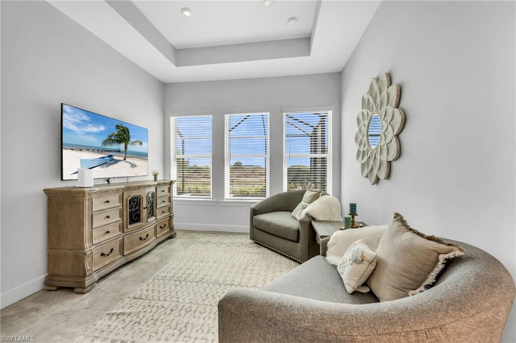 3410 Wellfleet Lane Naples, FL 34114 - Photo 12 of 28 a living room with furniture and a flat screen tv