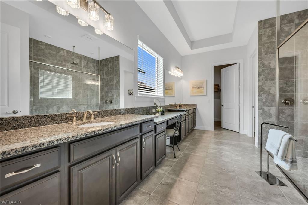 3410 Wellfleet Lane Naples, FL 34114 - Photo 13 of 28 a kitchen with granite countertop a sink and a stove