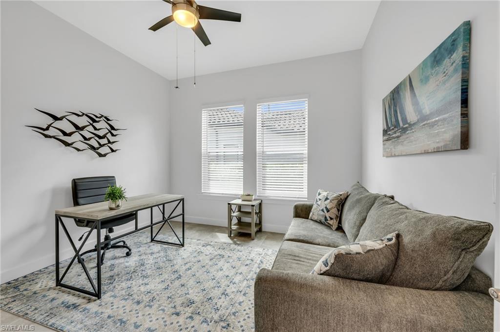 3410 Wellfleet Lane Naples, FL 34114 - Photo 14 of 28 a living room with furniture and a window