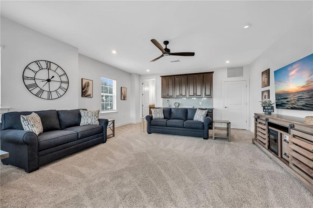 3410 Wellfleet Lane Naples, FL 34114 - Photo 15 of 28 a living room with furniture and a flat screen tv