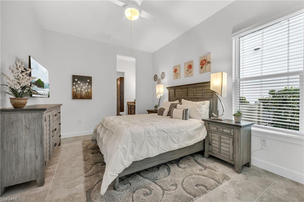 3410 Wellfleet Lane Naples, FL 34114 - Photo 17 of 28 a bed room with a bed and dresser