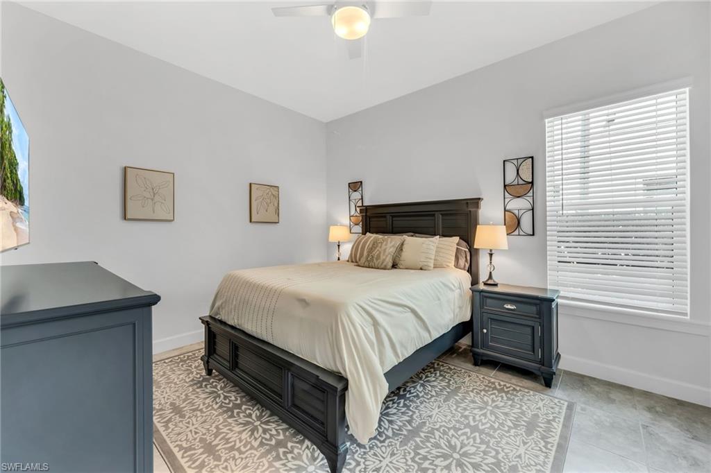 3410 Wellfleet Lane Naples, FL 34114 - Photo 19 of 28 a bedroom with a bed and a window