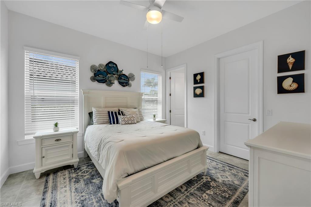 3410 Wellfleet Lane Naples, FL 34114 - Photo 20 of 28 a bedroom with a bed and a window