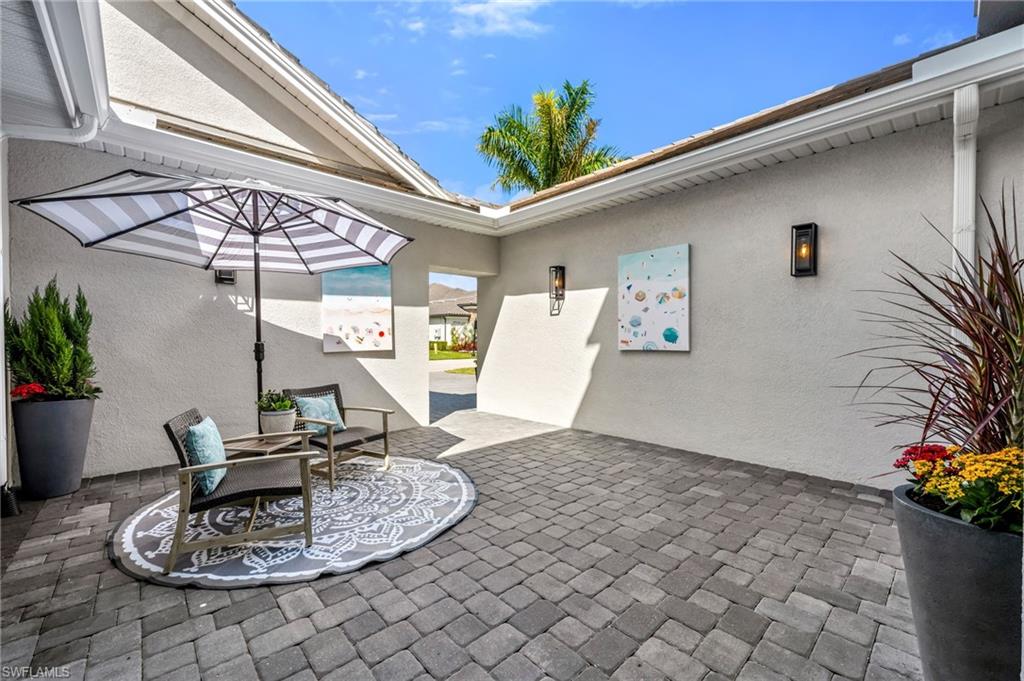3410 Wellfleet Lane Naples, FL 34114 - Photo 2 of 28 a dining room with a table and chairs