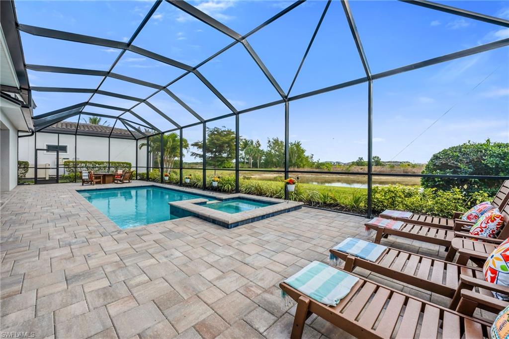 3410 Wellfleet Lane Naples, FL 34114 - Photo 22 of 28 a view of a swimming pool with a patio